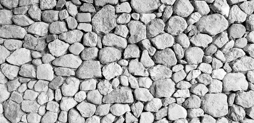 Gray stone or rock wall for background in black and white style - Abstract or Art wallpaper, Surface, Floor, Design and Exterior decoration concept 