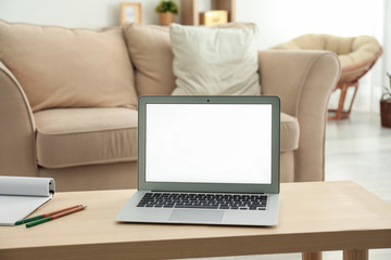 Modern laptop on table in room