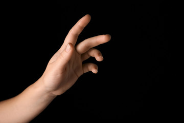 Female hand on dark background
