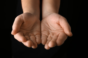 Female hands on dark background