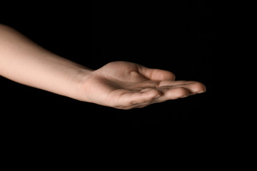 Female hand on dark background
