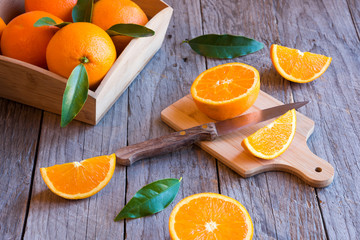 Fresh cut oranges on wooden table
