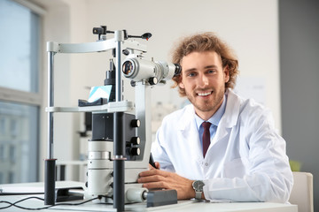 Portrait of young ophthalmologist in office