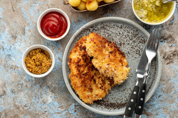 Wiener schnitzel with potato balls and lemon sauce. Chicken schnitzel in breading