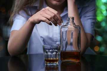 Depressed woman after divorce drinking alcohol in bar