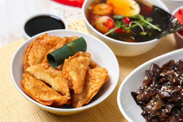 Tasty Chinese dumplings in bowl on table