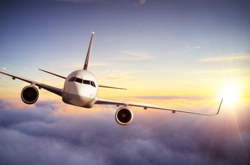 Passengers commercial airplane flying above clouds