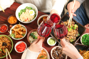 Friends with glasses of wine in Chinese restaurant, closeup - Powered by Adobe