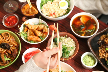 Woman eating tasty Chinese food, closeup