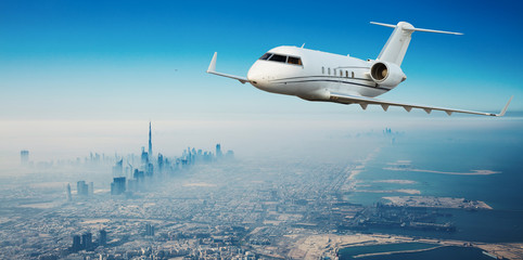 Private jet plane flying above Dubai city