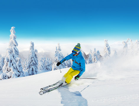 Young man skiing on piste