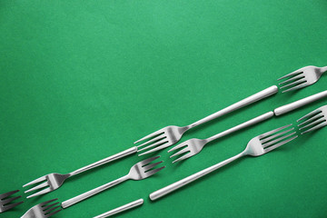Set of forks on color background