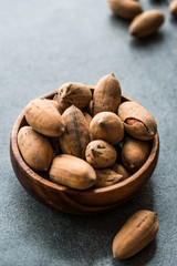 Pecan Nuts with Shell in Wooden Bowl / Walnuts.