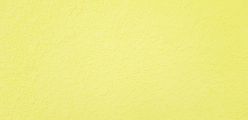 Rough yellow concrete wall for background - Painted wallpaper and Surface of material concept 