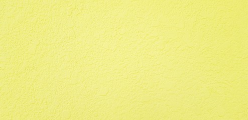 Rough yellow concrete wall for background - Painted wallpaper and Surface of material concept 