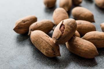 Pecan Nuts with Shell in Wooden Bowl / Walnuts.
