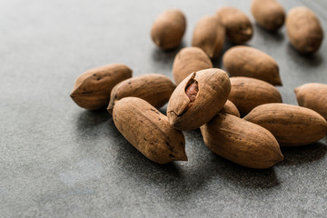 Pecan Nuts with Shell in Wooden Bowl / Walnuts.