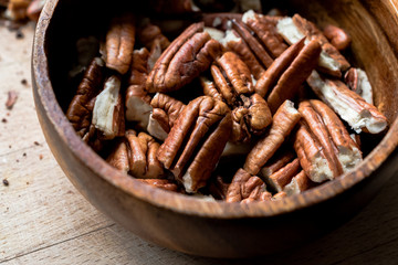 Peeled Pecan Nuts in Wooden Bowl without Shell / Walnuts.