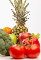 Set of bright juicy fruits and vegetables, white background.