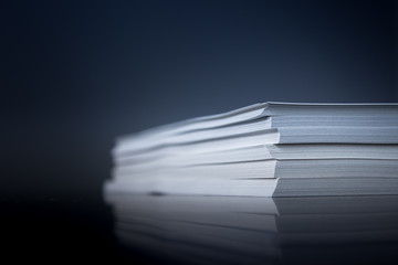 Stack of paper with mirroring and space for text