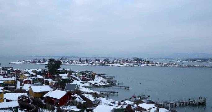 Panoramic shot of ostra near Oslo in Norway with a view of the sea and beautiful local houses during winter covered with snow.