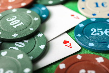 Chips and cards on table in casino, closeup