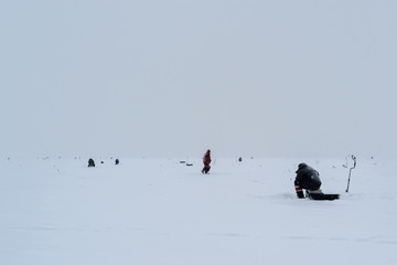 Group of fishermen on winter fishing