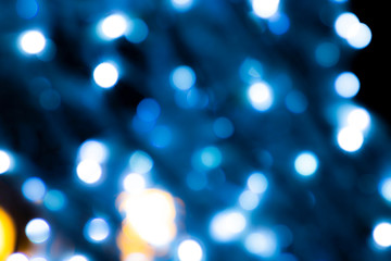 Fototapeta premium Abstract blurred blue circles on dark background.