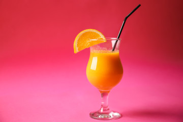 Glass of tasty smoothie on color background