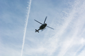 Underneath view of rescue helicopter flying above.
