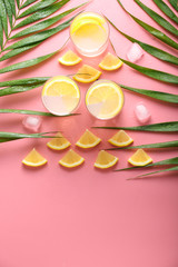 Creative composition with glasses of tasty cold lemonade on color background