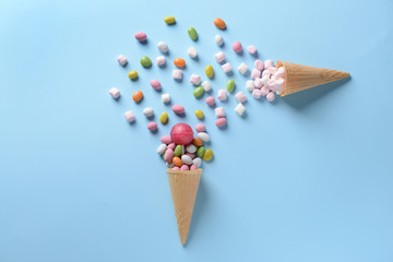 Composition with tasty candies on color background