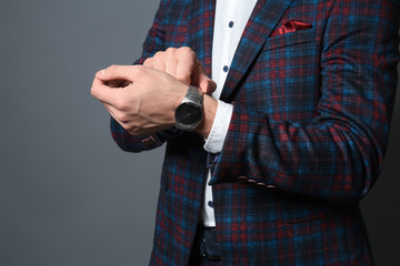 Fashionable young man in formal clothes on grey background