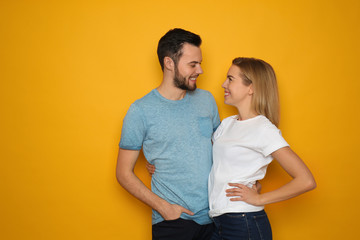 Stylish young couple on color background