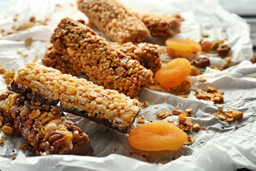Tasty granola bars on table