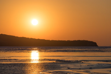 Winter seascape with ice floes on the water surface.