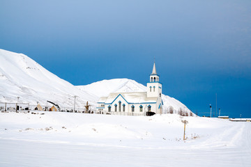 White church surrounded by snow in iceland during winter