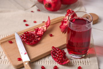 Glass of tasty pomegranate juice on table
