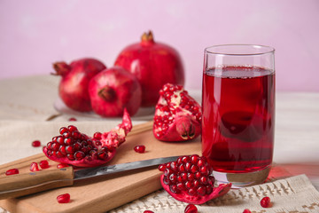 Glass of tasty pomegranate juice on table