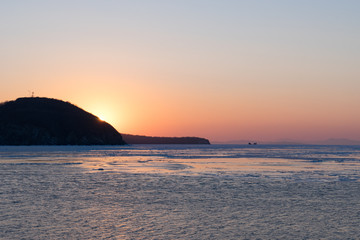 Winter seascape with ice floes on the water surface.