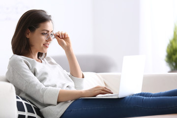 Young woman working with laptop at home