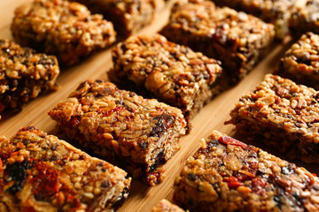Tasty granola bars on wooden background
