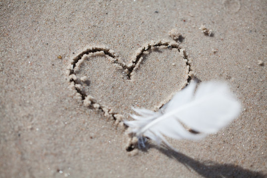 heart drawn on the sand, on the beach. heart drawn with a pen