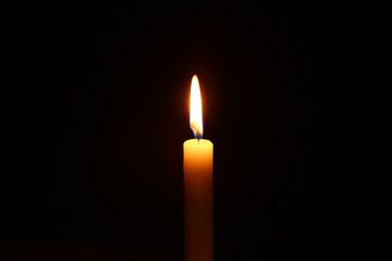 Beautiful burning candle on dark background