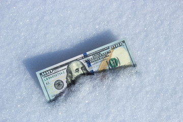 American currency lies in the snow
