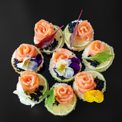 Delicious appetizer with salmon and edible flowers. Concept for food, restaurant, menu, catering.