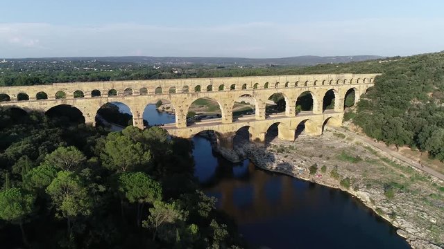 Aerial footage of Pont du Gard is an ancient Roman aqueduct that crosses the Gardon River near the town of Vers-Pont-du-Gard in southern France and popular tourist destination 4k high resolution