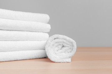 Fototapeta na wymiar Clean soft towels on color background