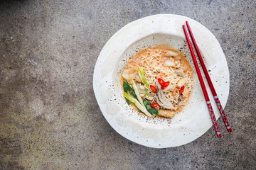 japanese ramen noodle with chicken, shiitake mushroms and egg in white bowl, top view