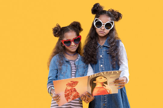 Pleasant Nice Girls Holding A Fashion Magazine